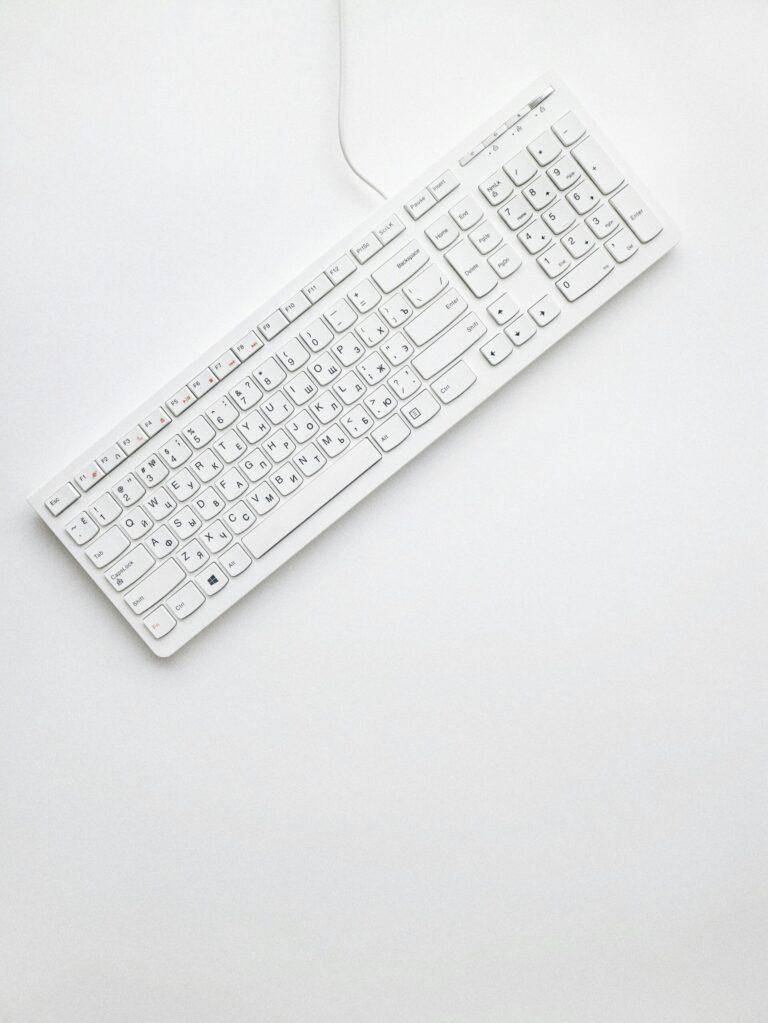 A modern white keyboard on a white background showcasing minimalist design and clean aesthetics.