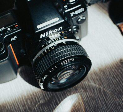 Close-up of a classic Nikon camera highlighting its vintage design and features.