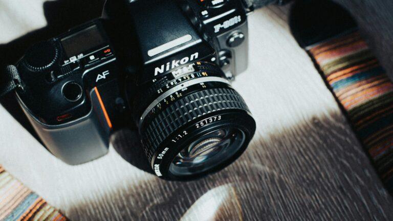 Close-up of a classic Nikon camera highlighting its vintage design and features.